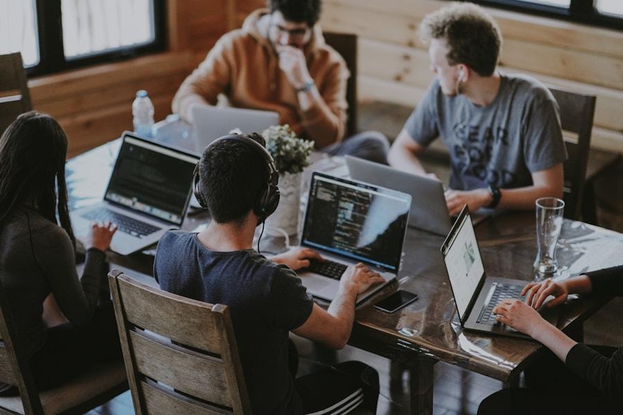 Team collaborating around laptops in a modern office